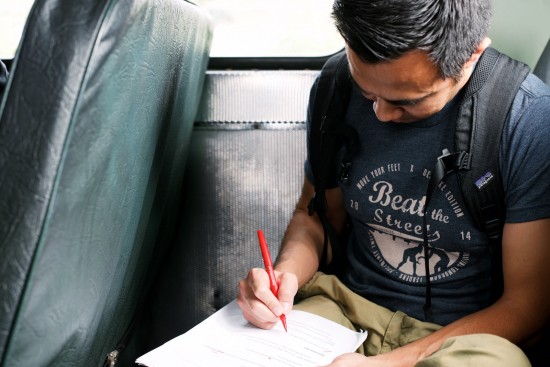 Board Member Brian Guerrero sits at the back of the bus to review notes during an on-location film project for Beat the Streets LA. Photo by Cal Bingham.